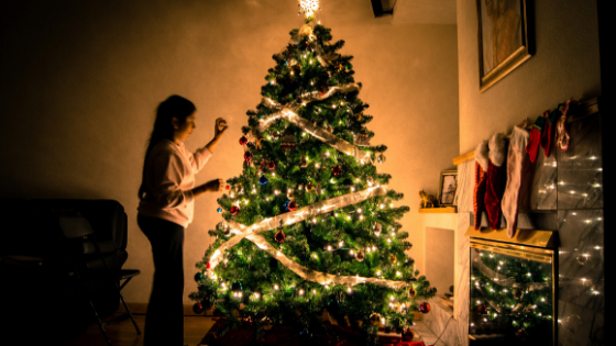 Girl setting up a Christmas tree