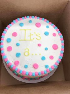Gender reveal cake with words It's a ...